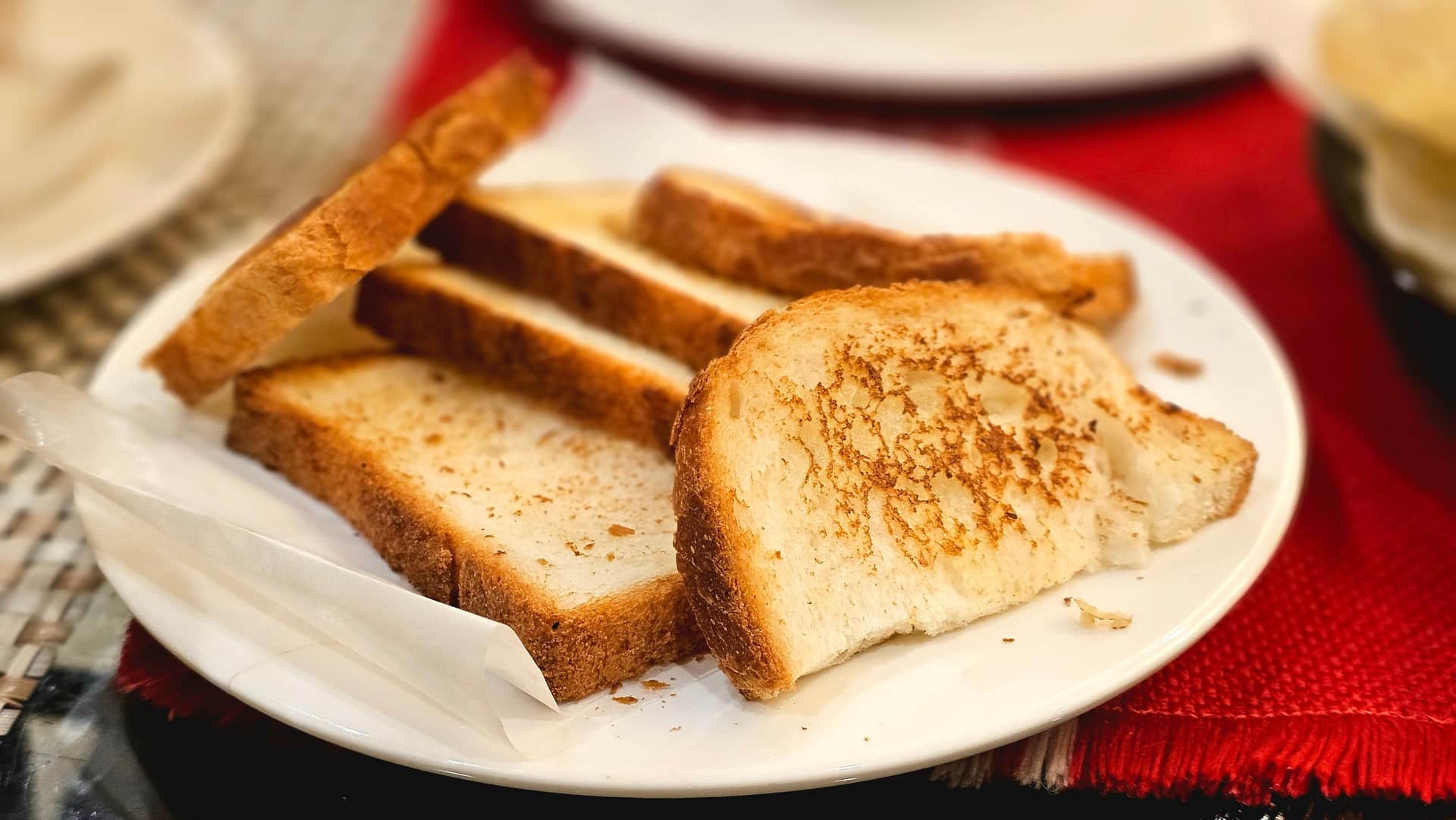 Slices of toast browned to different shades on a plate