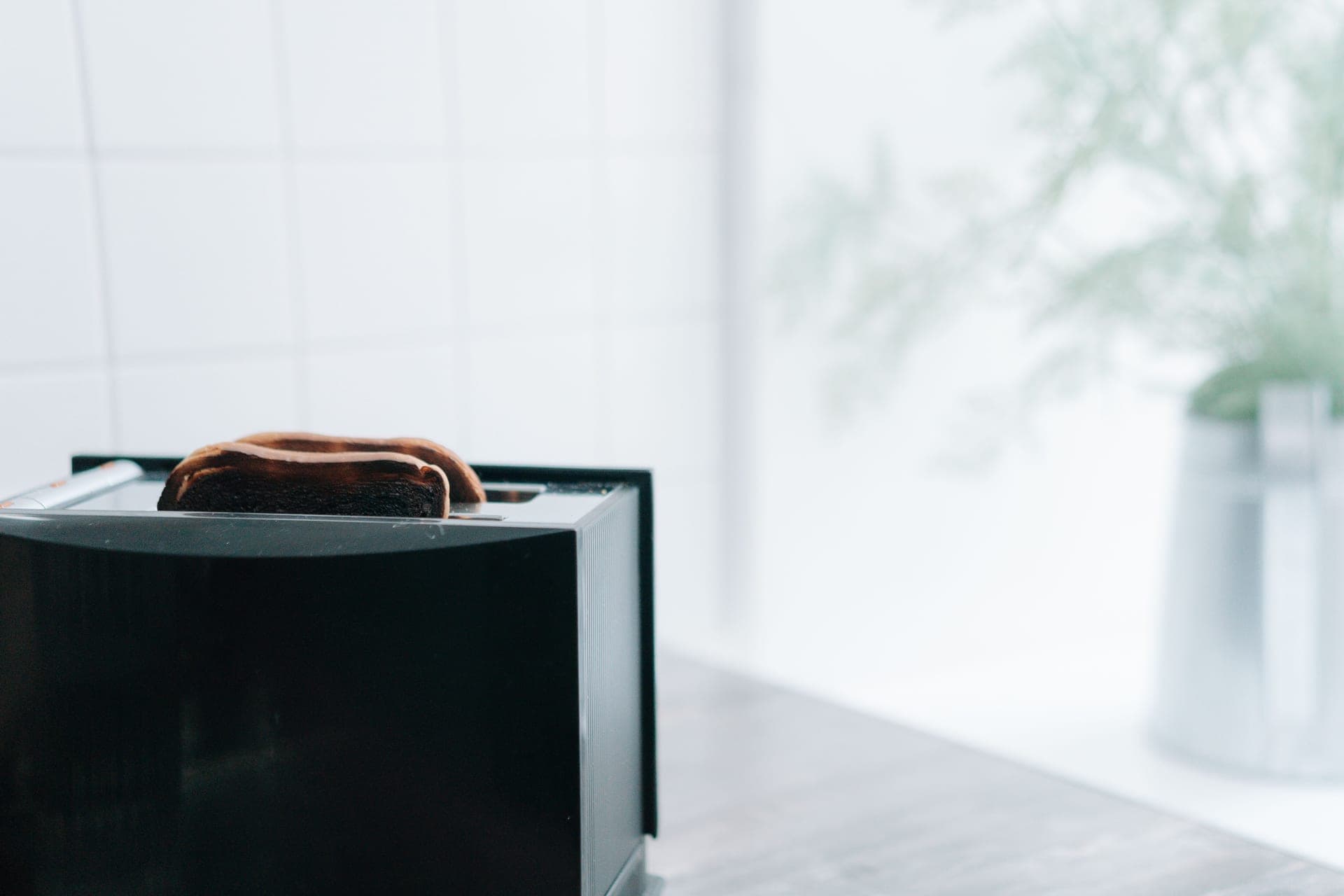 A toaster on a kitchen counter in morning light
